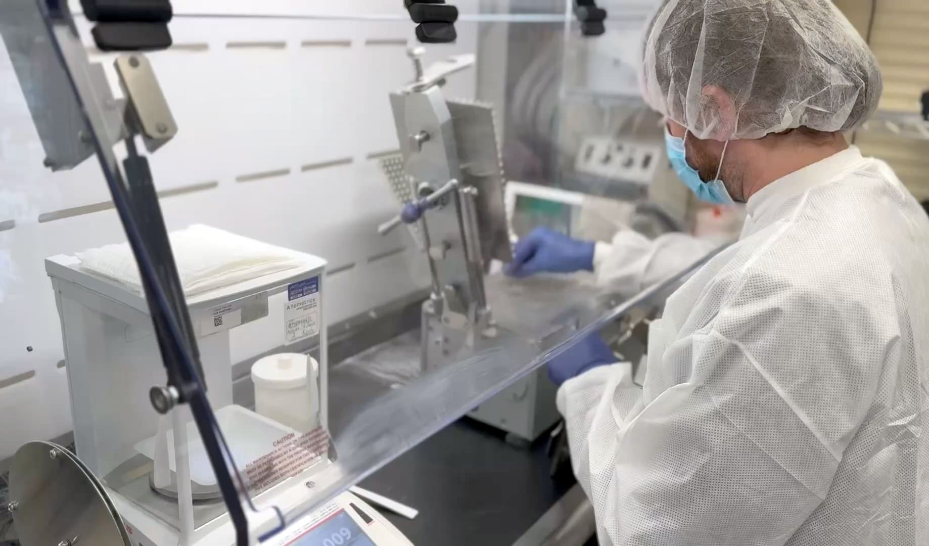 Medical professional in surgical attire preparing medication
